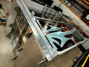 Interior of the ICON Auto Vault showing a custom-engineered restraint system securing a high-value vehicle for international transport